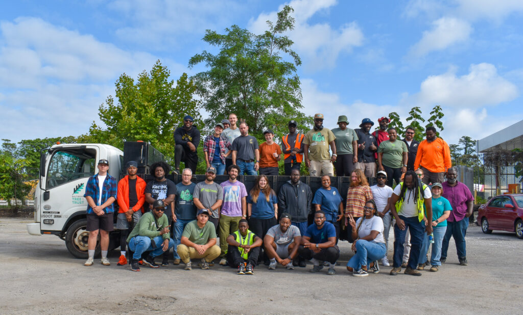 A photo of over 40 Baltimore Tree Trust staff in front of a white stake-bed truck.